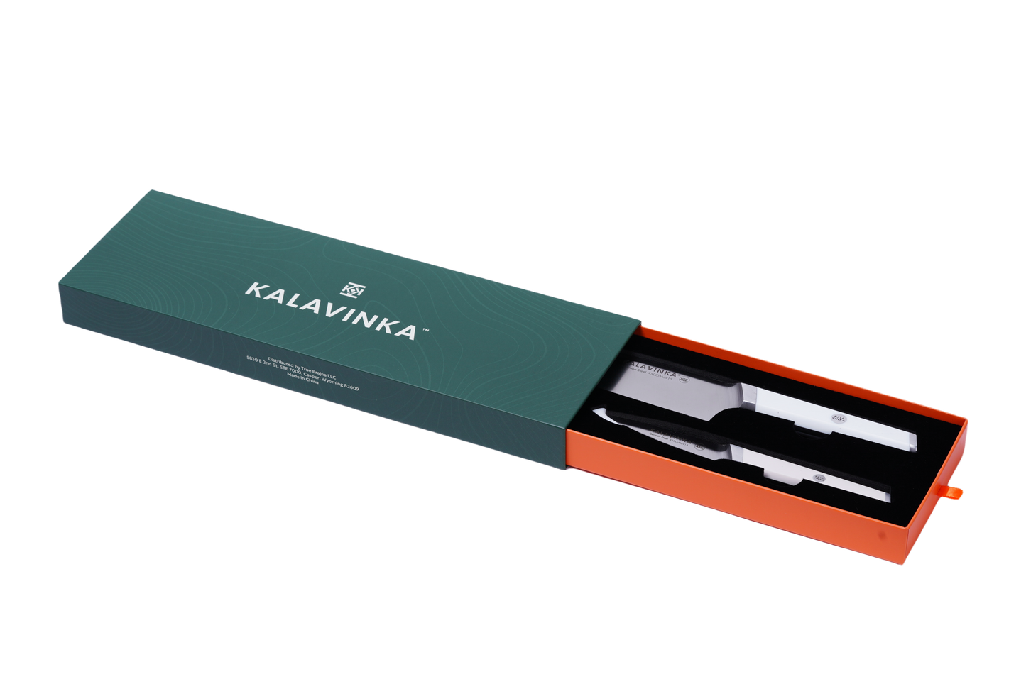 A green rectangular box labeled "KALAVINKA," with an orange interior, is partially slid open to reveal the VENDANA Series 2-Piece Starter Knife Set, featuring two stainless steel kitchen utensils made from forged German X50CrMov15 steel. The utensils, showcasing ergonomic white handles, include a razor-sharp knife and a large fork, both neatly arranged inside the box.
