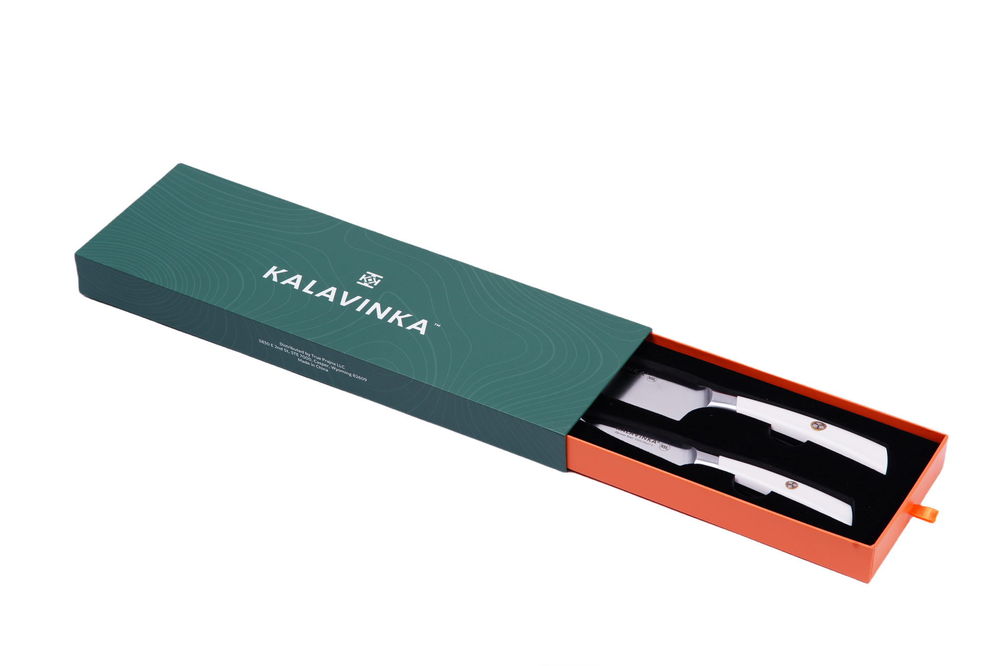 A green rectangular box labeled "KALAVINKA," with an orange interior, is partially slid open to reveal the VENDANA Series 2-Piece Starter Knife Set, featuring two stainless steel kitchen utensils made from forged German X50CrMov15 steel. The utensils, showcasing ergonomic white handles, include a razor-sharp knife and a large fork, both neatly arranged inside the box.