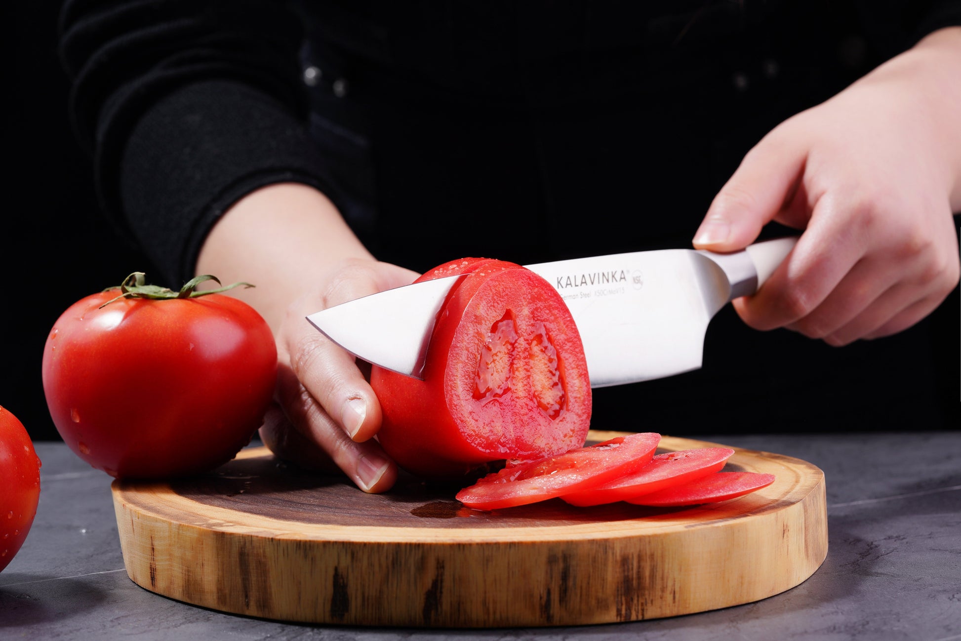 Using a Chef's Knife from a 2PC Knife Set, a person cuts a tomato with precision, showcasing the razor-sharp blade.